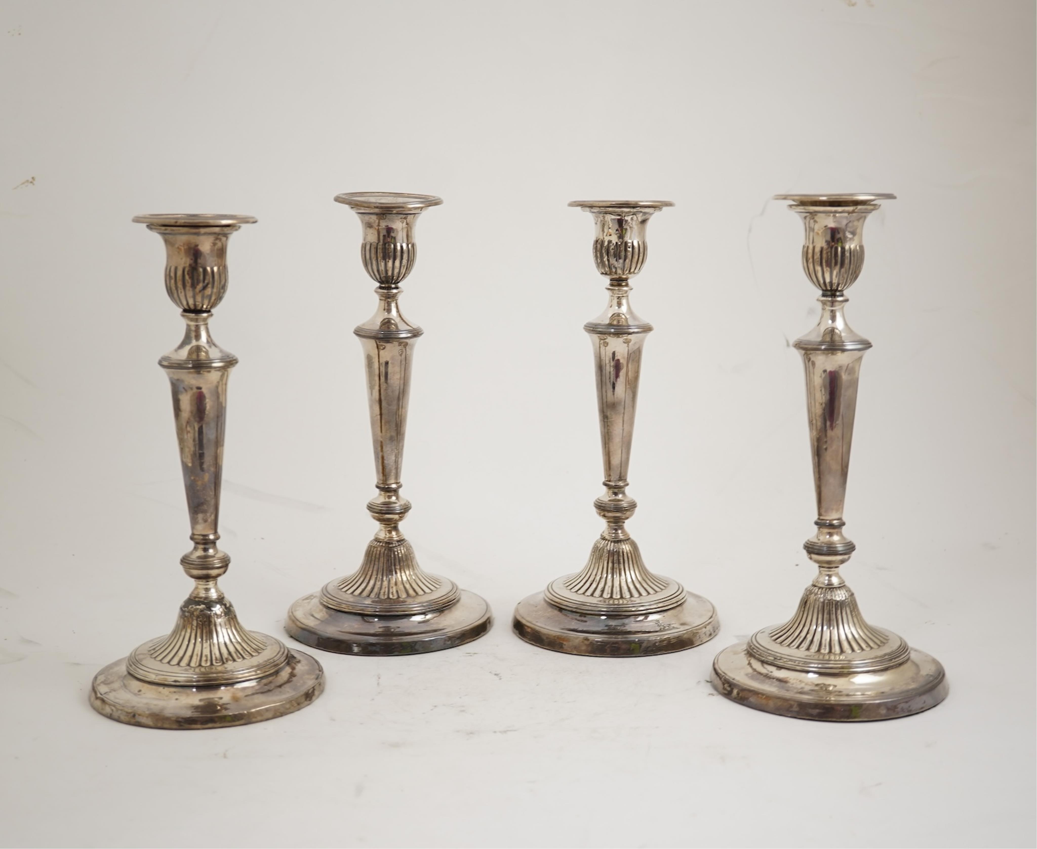 A set of four George III silver candlesticks by John Green, Roberts, Mosley & Co, with waisted turned stems, on circular foot, Sheffield, 1801, (repair), 27.5cm, loaded.